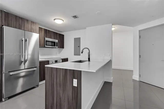 a kitchen with stainless steel appliances a refrigerator and a sink