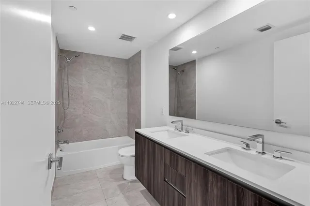 a bathroom with a sink double vanity and a shower