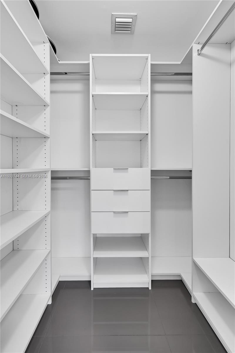 488 Northeast 18th Street, Unit 2311 Miami, FL 33132 - Photo 22 of 40 a view of walk in closet with empty racks