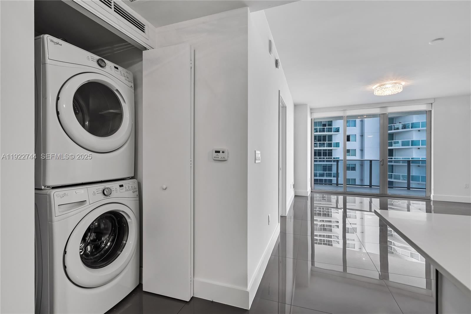 488 Northeast 18th Street, Unit 2311 Miami, FL 33132 - Photo 27 of 40 a view of a hallway with washer and dryer