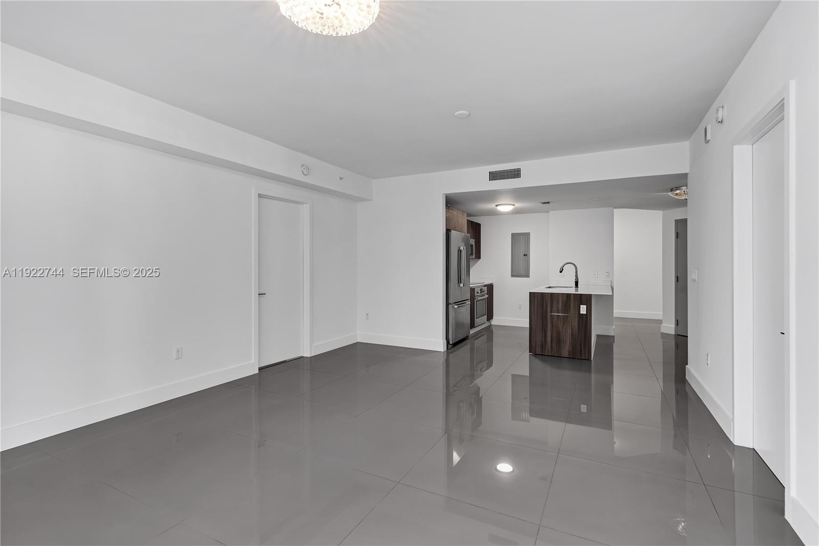 488 Northeast 18th Street, Unit 2311 Miami, FL 33132 - Photo 10 of 40 a view of a living room hardwood floor and a kitchen