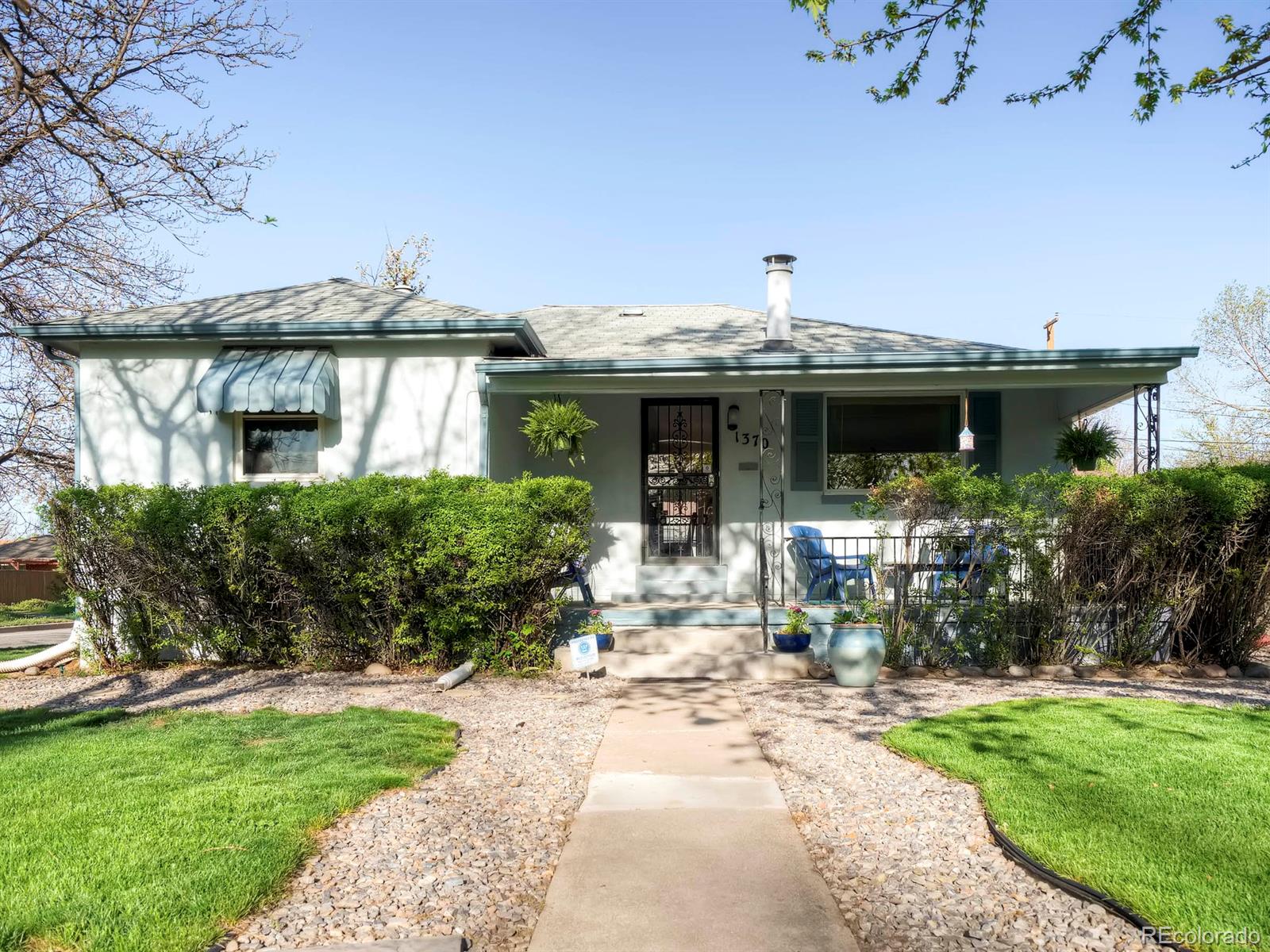 1370 Olive Street Denver, CO 80220 - Photo 1 of 27 a front view of a house with swimming pool and furniture