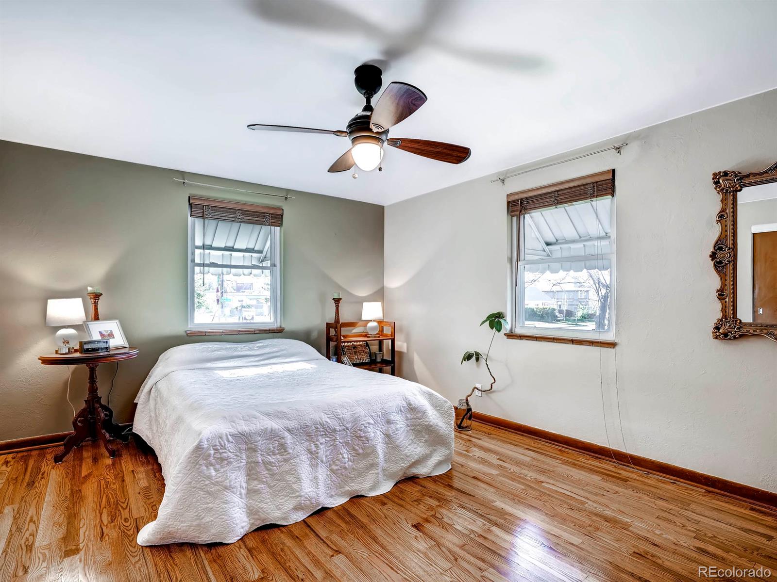 1370 Olive Street Denver, CO 80220 - Photo 11 of 27 a bedroom with a bed and wooden floor