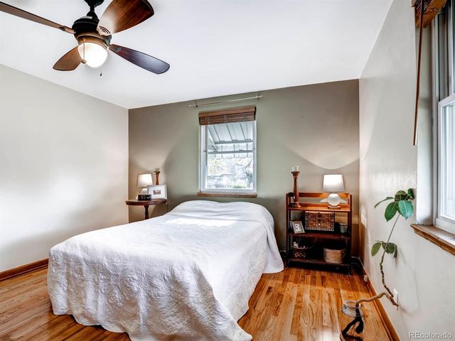 a bedroom with a bed dresser and a chandelier
