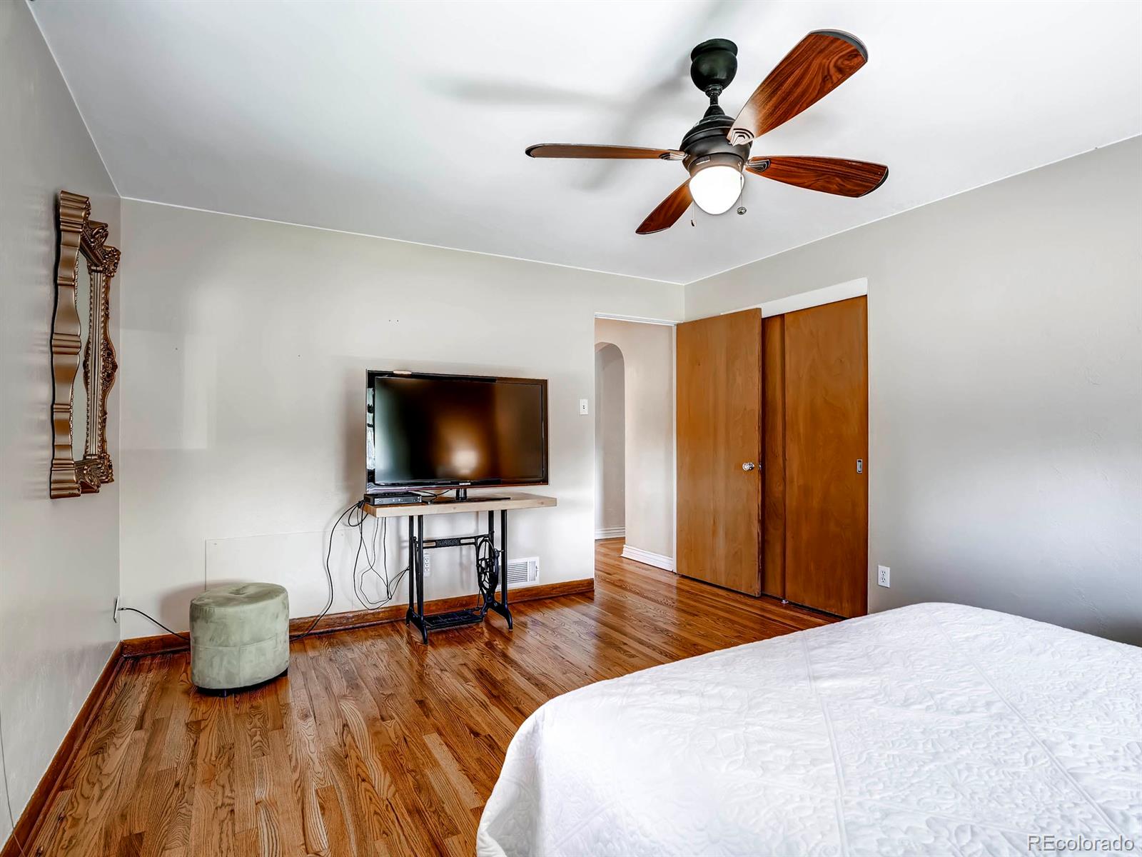 1370 Olive Street Denver, CO 80220 - Photo 13 of 27 a bedroom with a bed and a flat screen tv