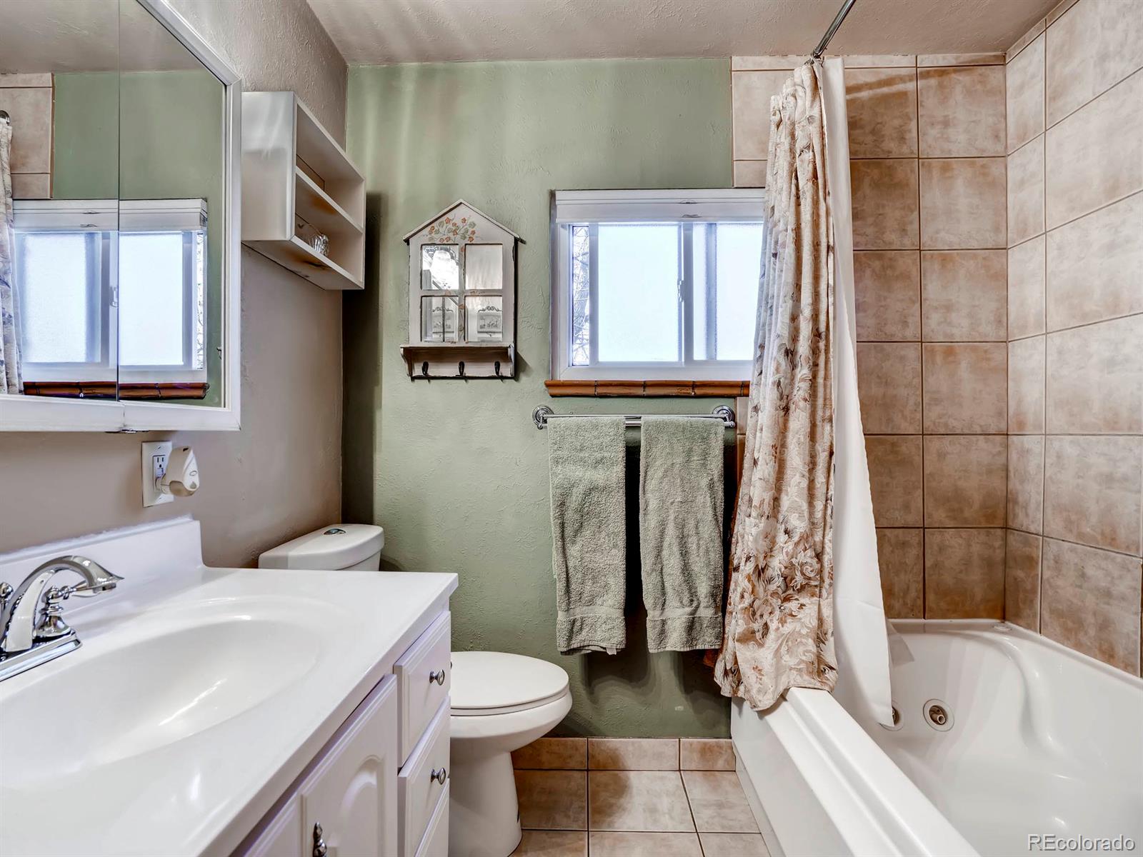 1370 Olive Street Denver, CO 80220 - Photo 14 of 27 a bathroom with a sink toilet and shower