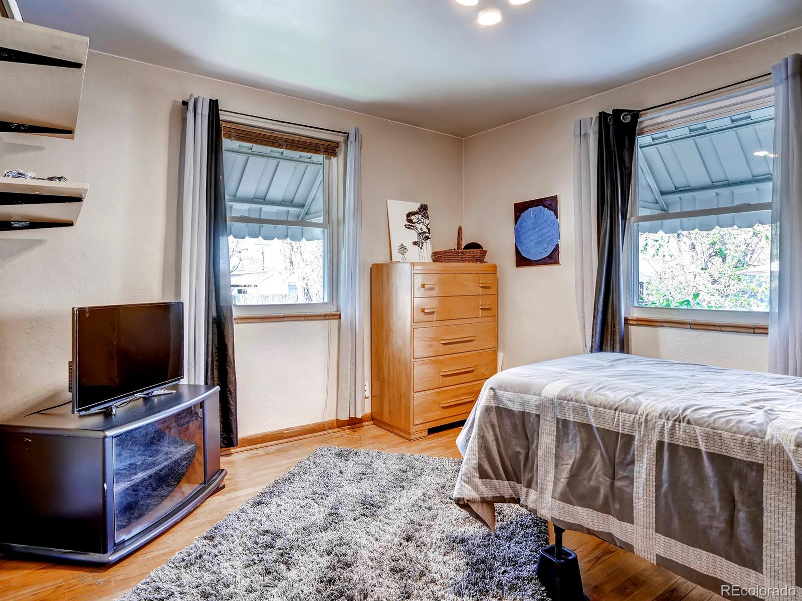 1370 Olive Street Denver, CO 80220 - Photo 15 of 27 a bedroom with a bed and flat screen tv