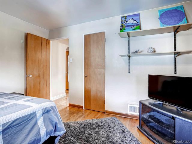 a bedroom with a bed and flat screen tv
