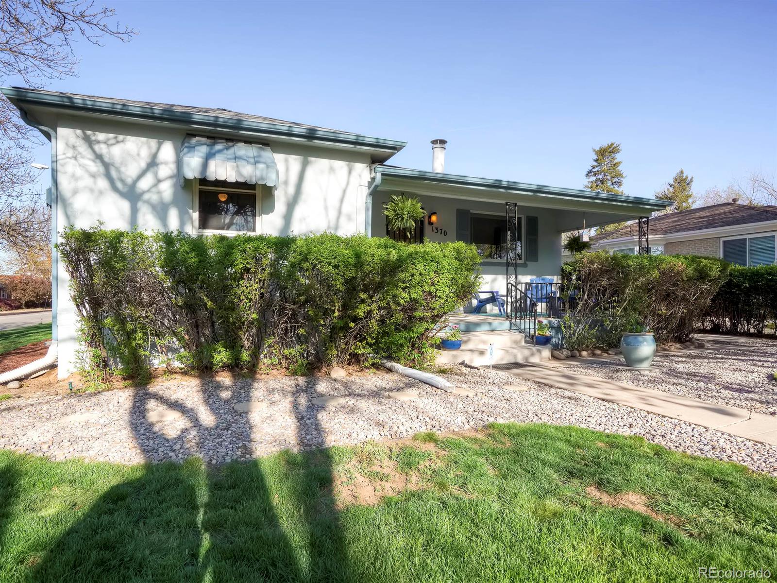 1370 Olive Street Denver, CO 80220 - Photo 18 of 27 a front view of a house with garden