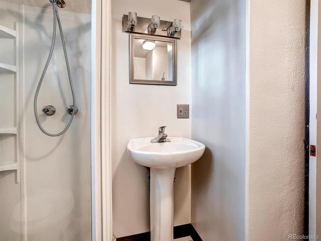 a bathroom with a sink a mirror and window