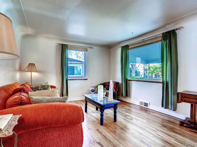 a bedroom with bed and wooden floor