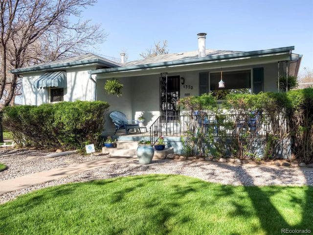 a view of a house with backyard sitting area and garden