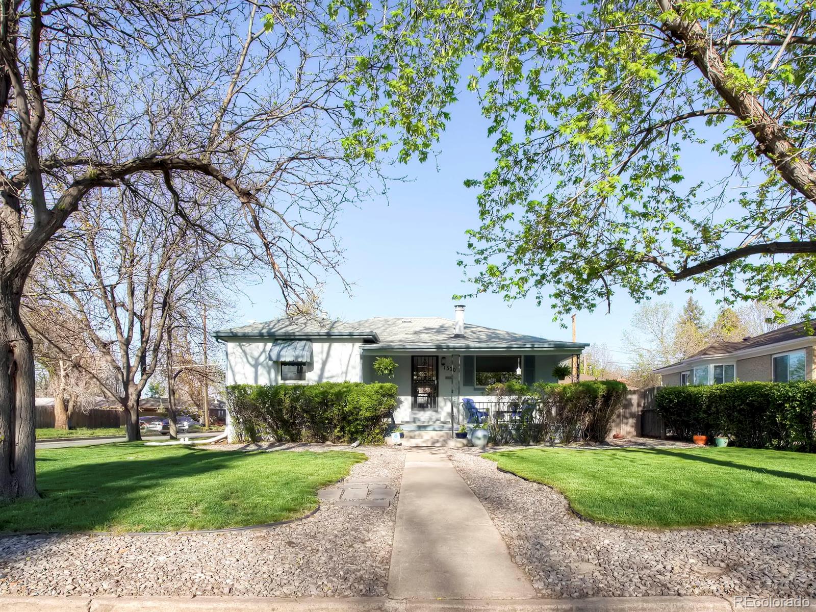 1370 Olive Street Denver, CO 80220 - Photo 25 of 27 a view of a patio with a table and chairs under an umbrella