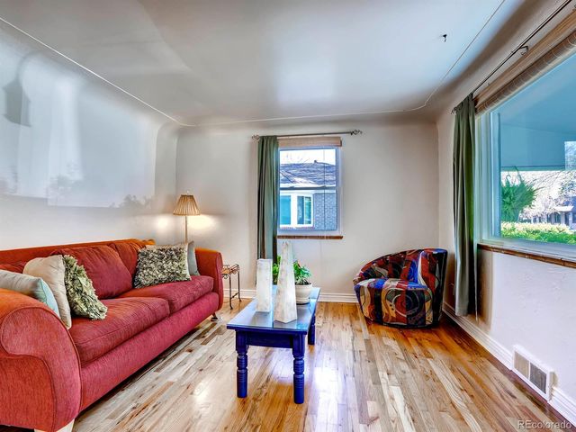 a living room with furniture a rug and a window