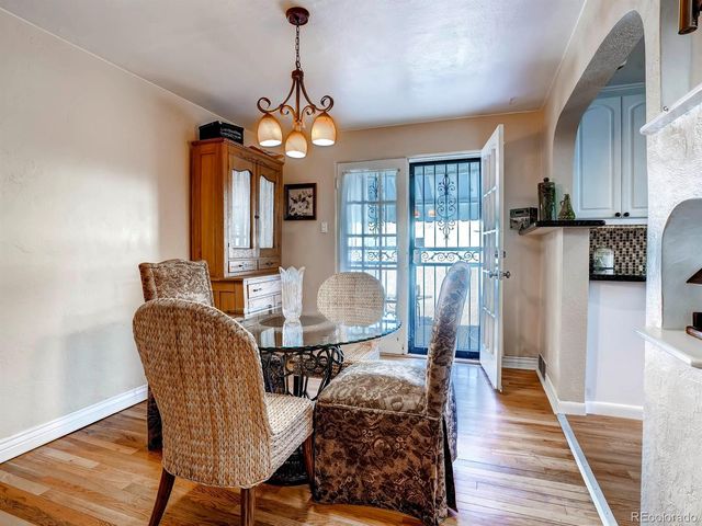 a dining room with furniture and wooden floor