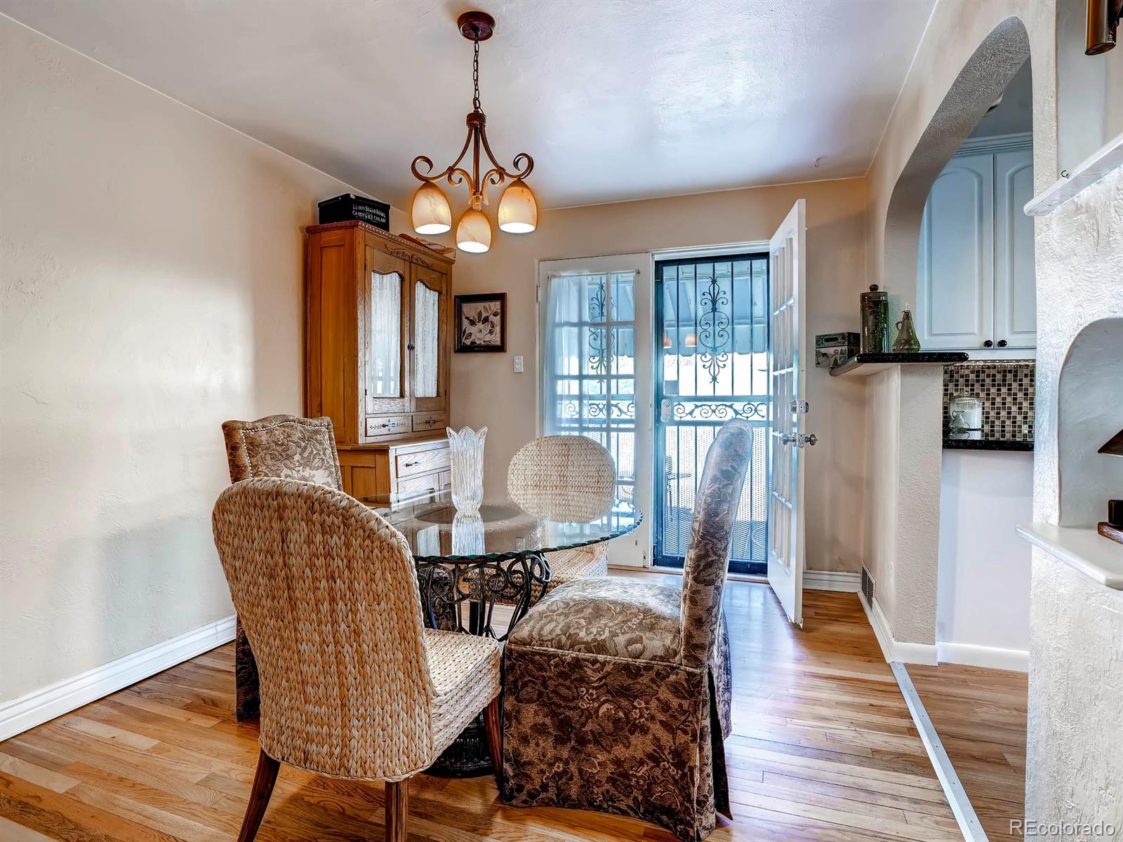 1370 Olive Street Denver, CO 80220 - Photo 6 of 27 a dining room with furniture and wooden floor