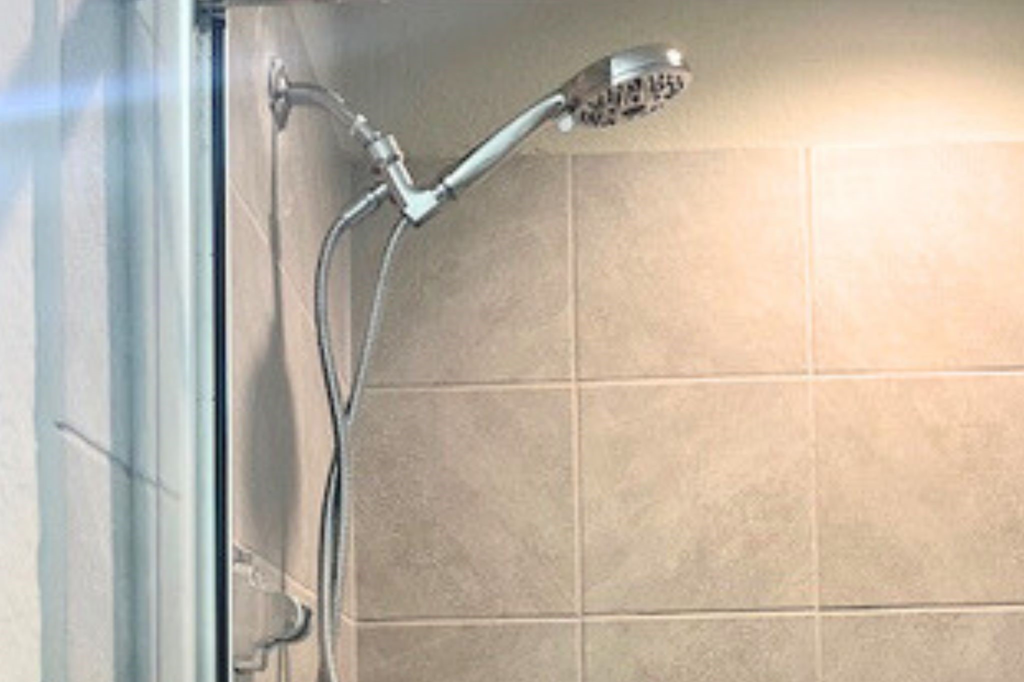 8310 Rose Petals Lane Rosharon, TX 77583 - Photo 15 of 43 Primary bathroom walk-in standing shower featuring tiled walls and a glass enclosure, offering a clean and modern design. Conveniently located next to the walk-in closet for easy access from the primary suite.