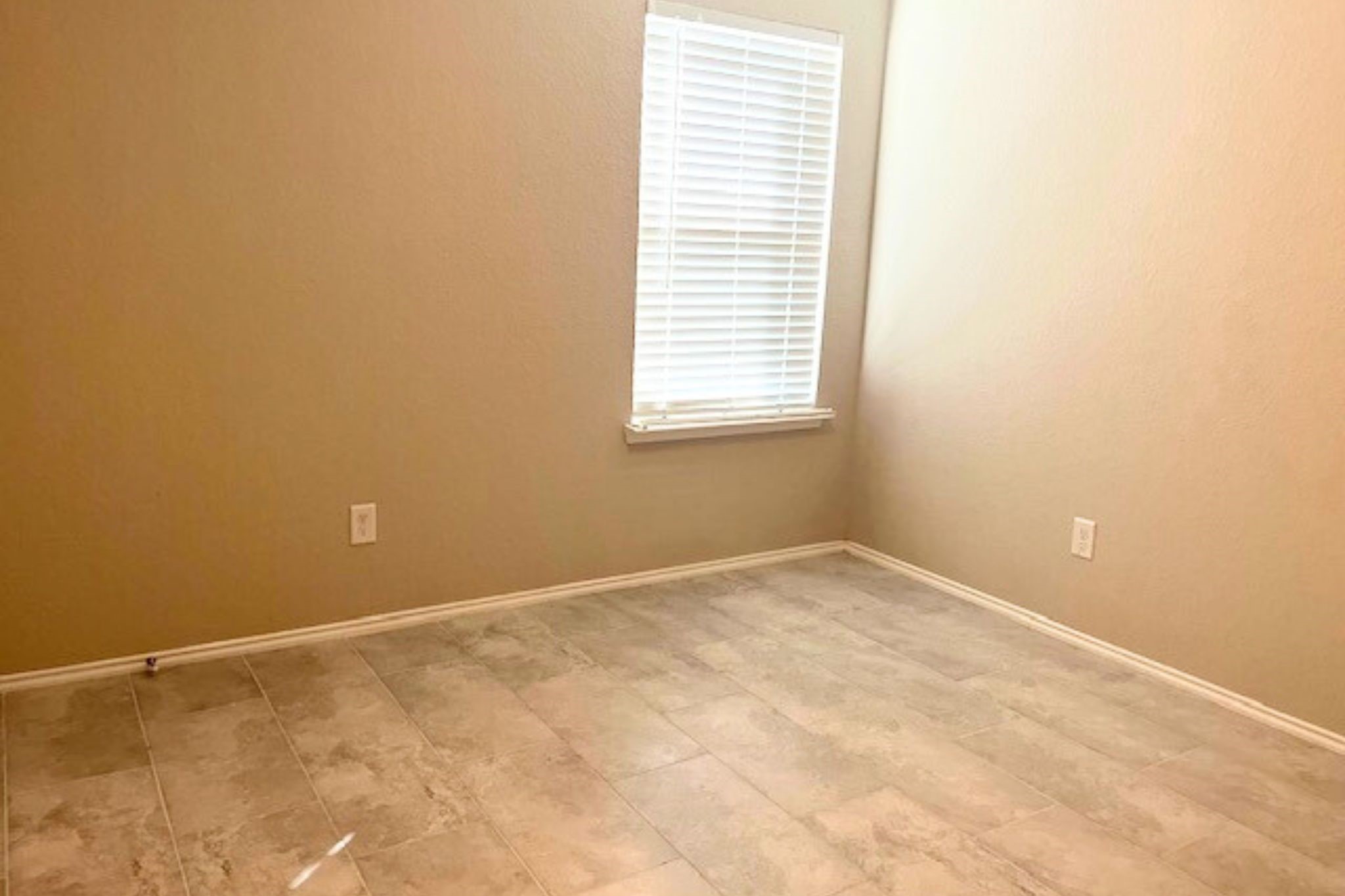 8310 Rose Petals Lane Rosharon, TX 77583 - Photo 22 of 43 Bedroom 3 is a comfortable secondary bedroom with tile flooring, neutral wall colors, and a window that brings in natural light. The room also includes a closet and offers a versatile space suitable for a bedroom, guest room, or home office