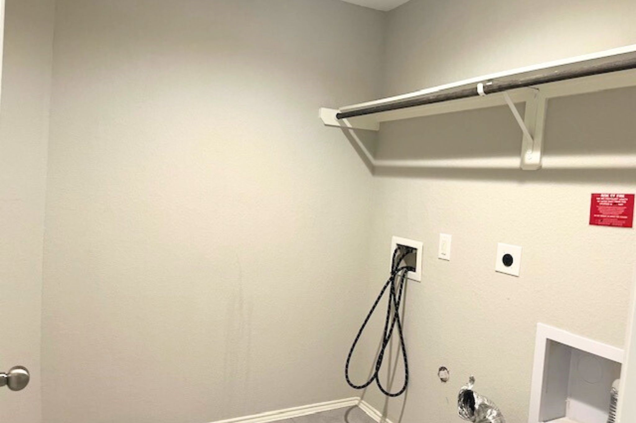 8310 Rose Petals Lane Rosharon, TX 77583 - Photo 24 of 43 Dedicated laundry area with washer and dryer connections, built-in shelving, and hanging space for added convenience. This functional space provides plenty of room for laundry and storage, making everyday household tasks easier and more organized.