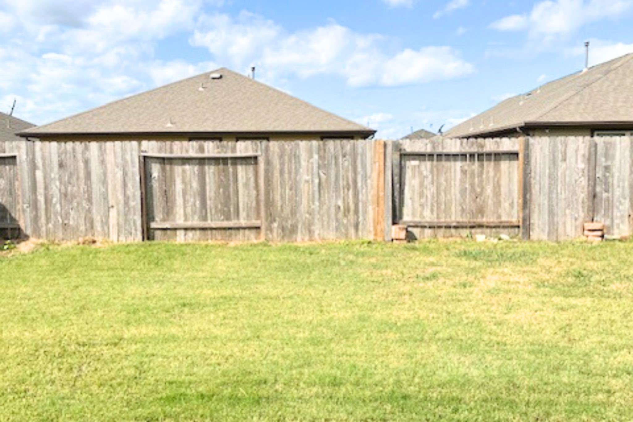 8310 Rose Petals Lane Rosharon, TX 77583 - Photo 28 of 43 Spacious fully fenced backyard with plenty of open green space, offering privacy and room for outdoor activities, gardening, or entertaining.