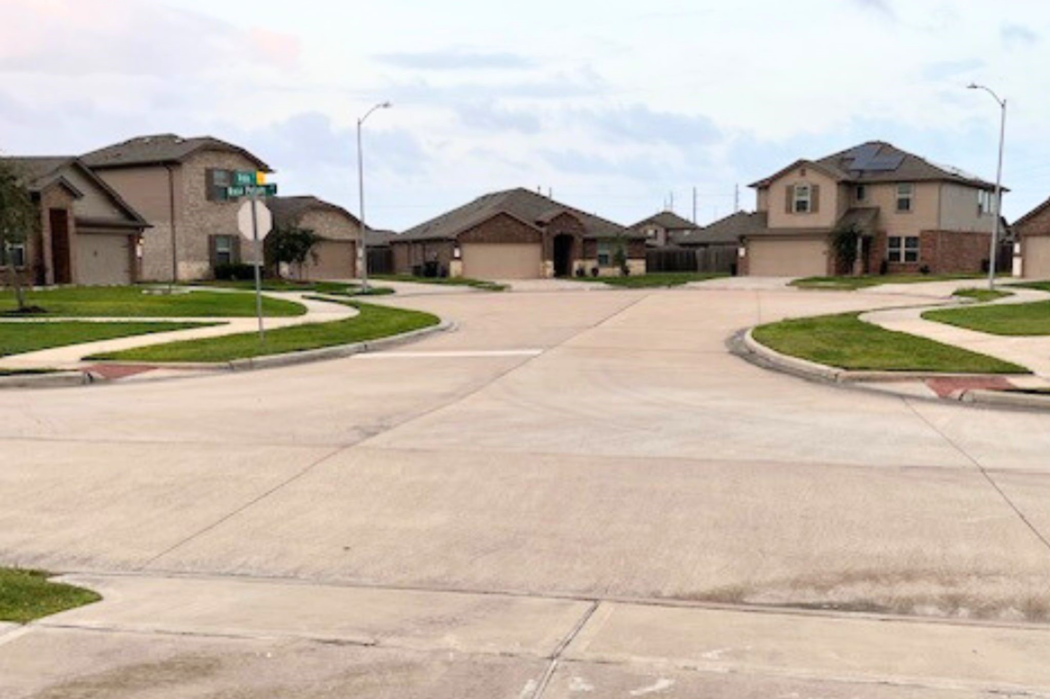8310 Rose Petals Lane Rosharon, TX 77583 - Photo 29 of 43 Beautiful open street view from the front of the home, showcasing a quiet neighborhood roundabout with well-maintained homes and landscaped sidewalks. This peaceful setting offers minimal through traffic, creating a safe, welcoming environment with an open view and spacious feel right from the front door—perfect for enjoying the charm of the Southern Colony community.