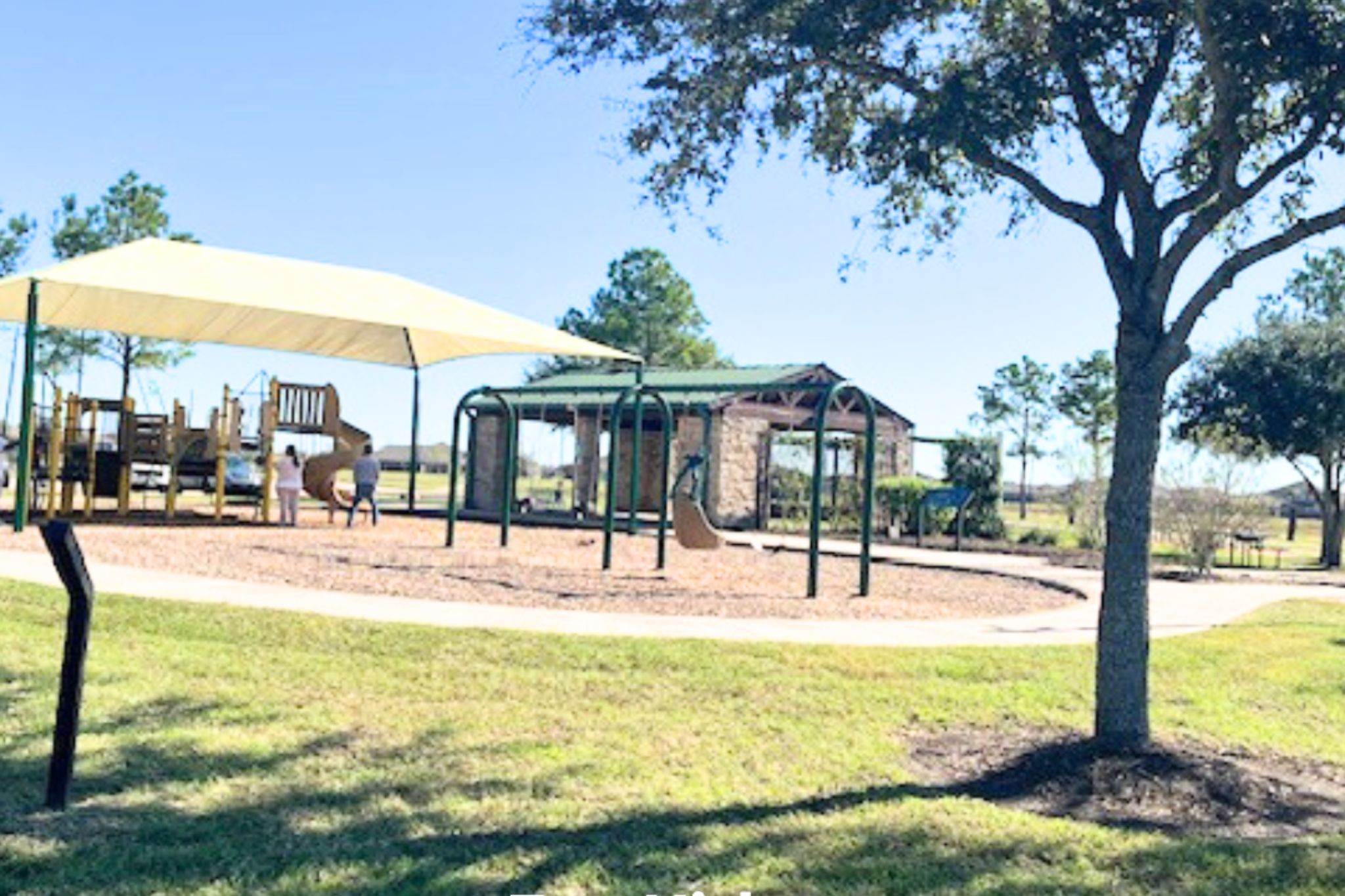 8310 Rose Petals Lane Rosharon, TX 77583 - Photo 32 of 43 Spacious community playground with shade canopy and swing area, surrounded by open green space. A great place for children to play while parents relax nearby.
