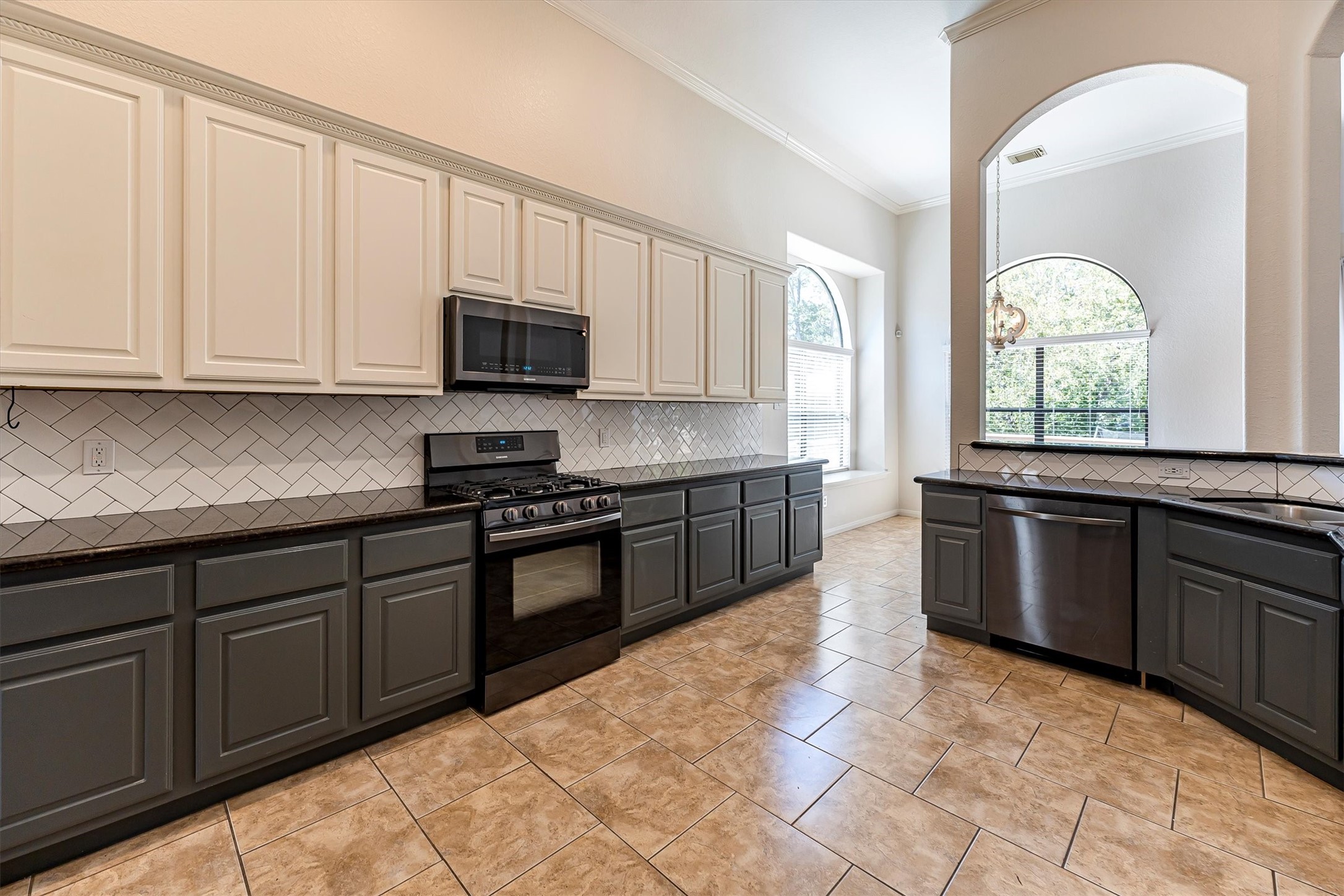 3517 Oak Landing Conroe, TX 77304 - Photo 11 of 28 a kitchen with granite countertop a stove sink and cabinets
