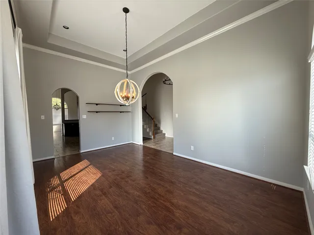 a view of a room with wooden floor and white walls
