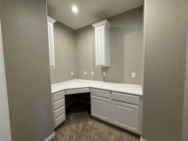 a room with two sink and cabinets