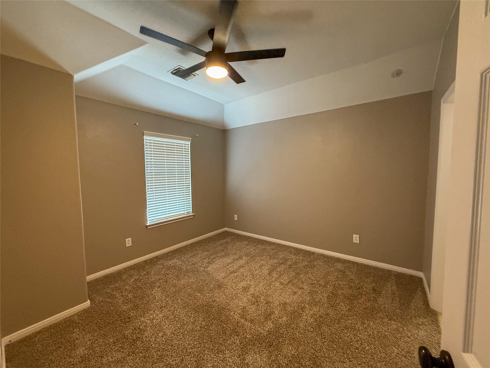 3517 Oak Landing Conroe, TX 77304 - Photo 26 of 28 an empty room with a ceiling fan and window