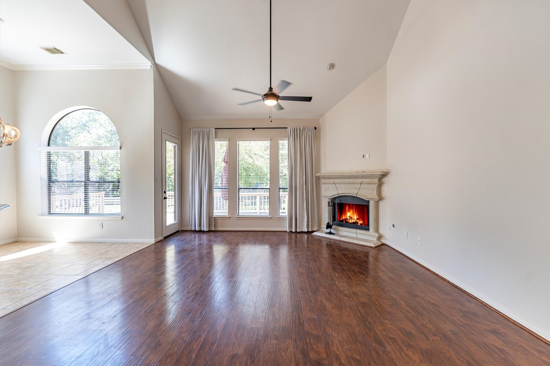 3517 Oak Landing Conroe, TX 77304 - Photo 5 of 28 a view of an empty room with wooden floor fireplace and a window