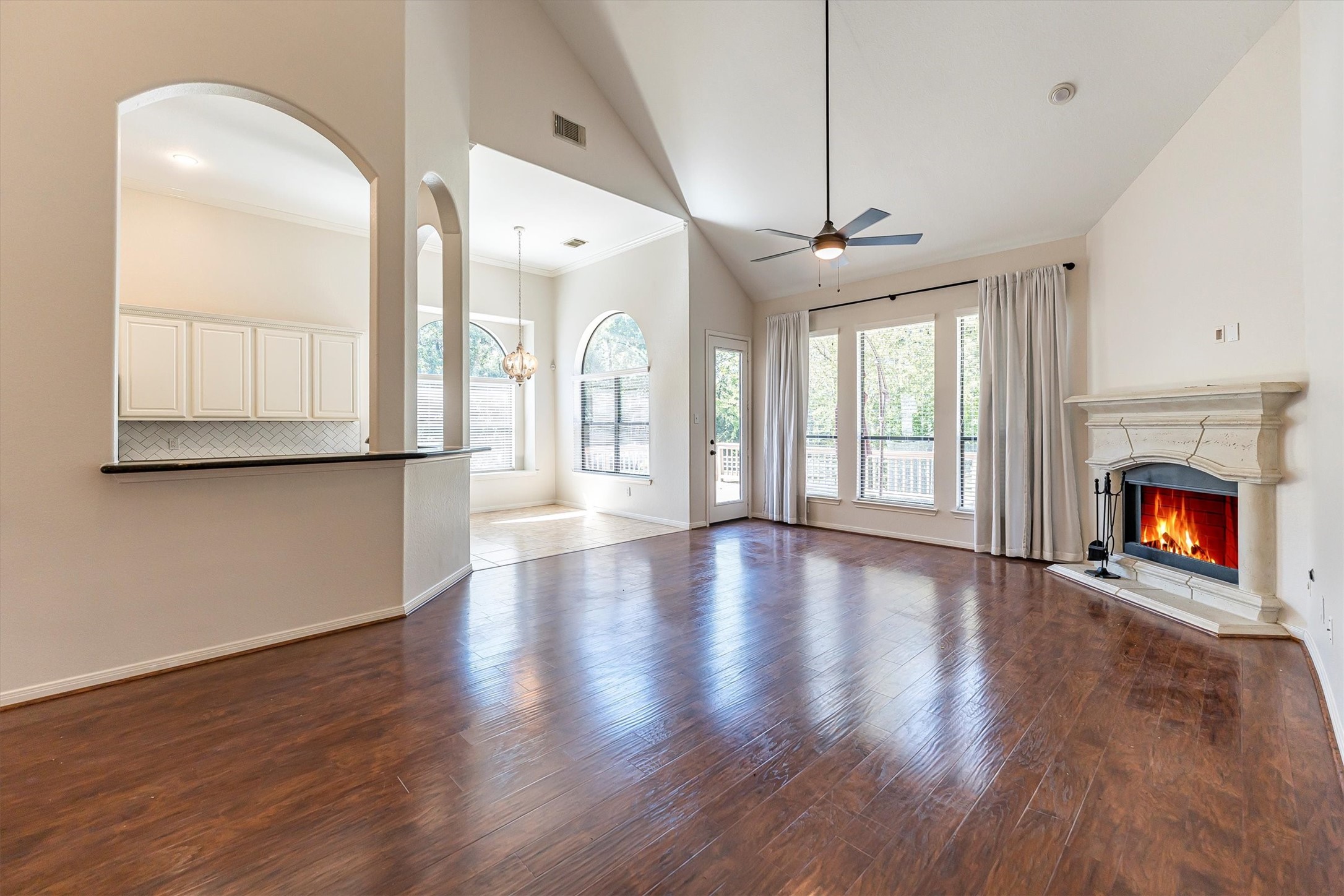 3517 Oak Landing Conroe, TX 77304 - Photo 7 of 28 a view of an empty room with wooden floor fireplace and a window
