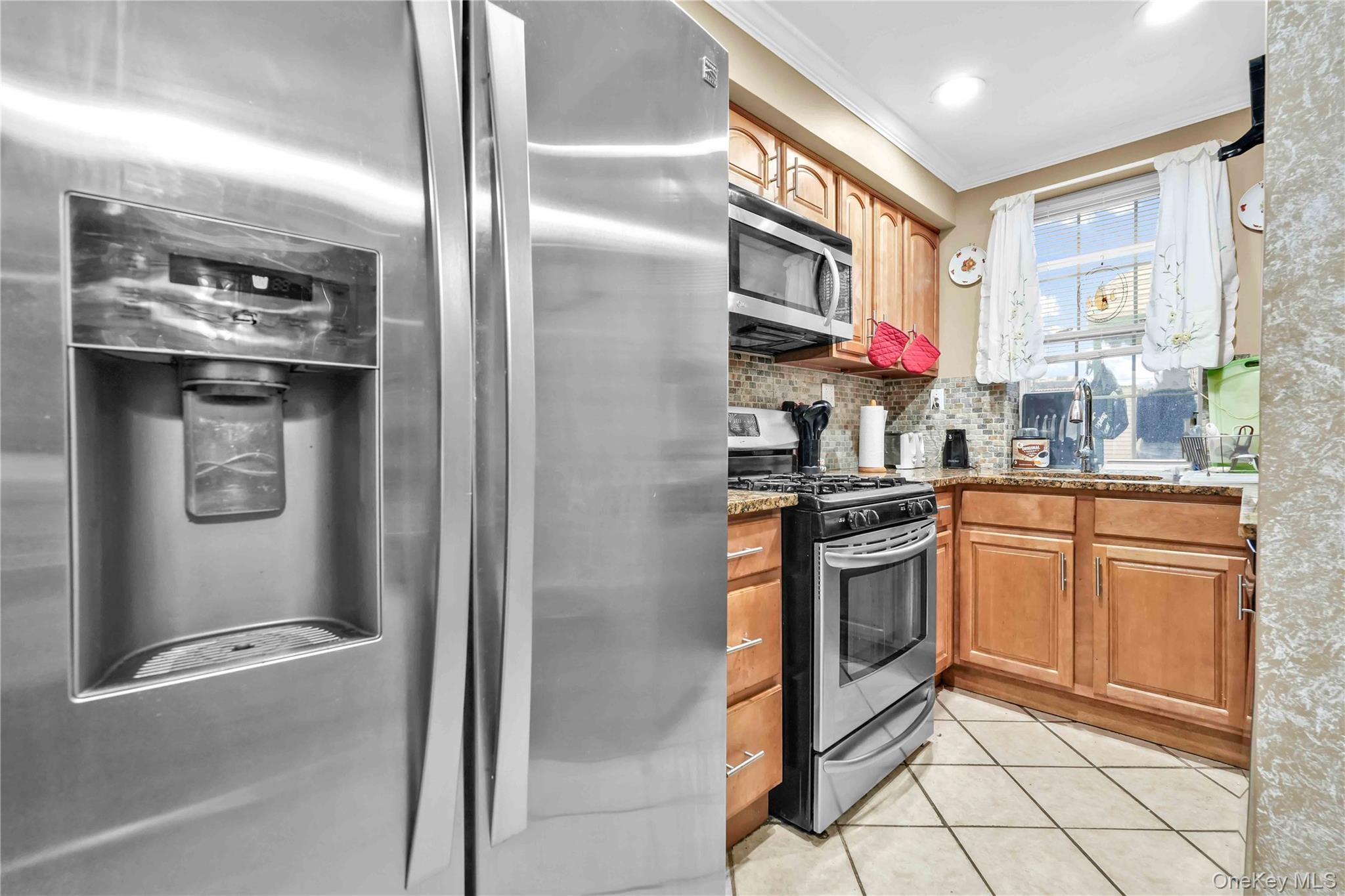1623 George Street Queens, NY 11385 - Photo 13 of 21 a kitchen with stainless steel appliances granite countertop a refrigerator and a sink