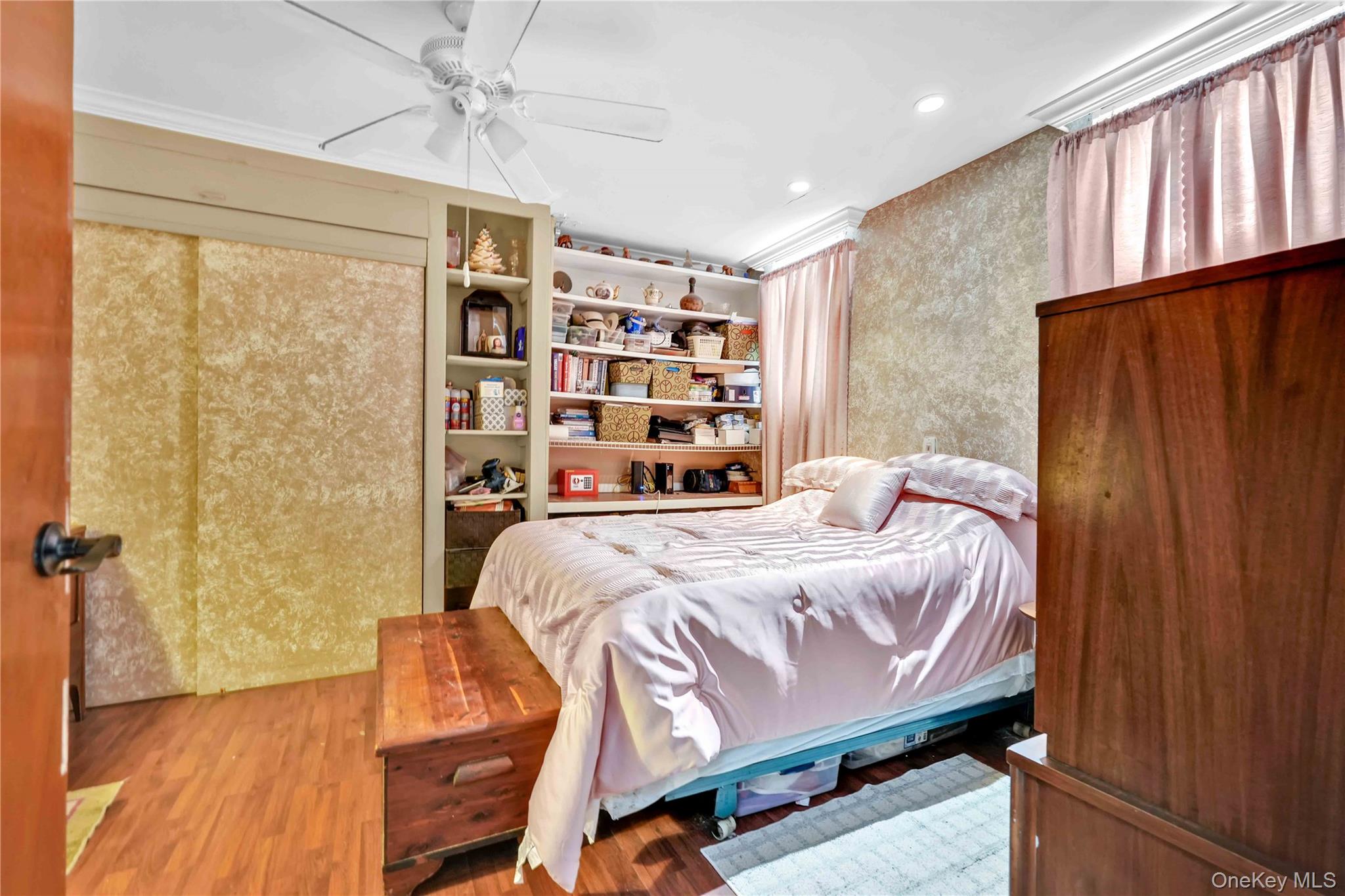1623 George Street Queens, NY 11385 - Photo 4 of 21 a bedroom with a bed a table and wooden floor