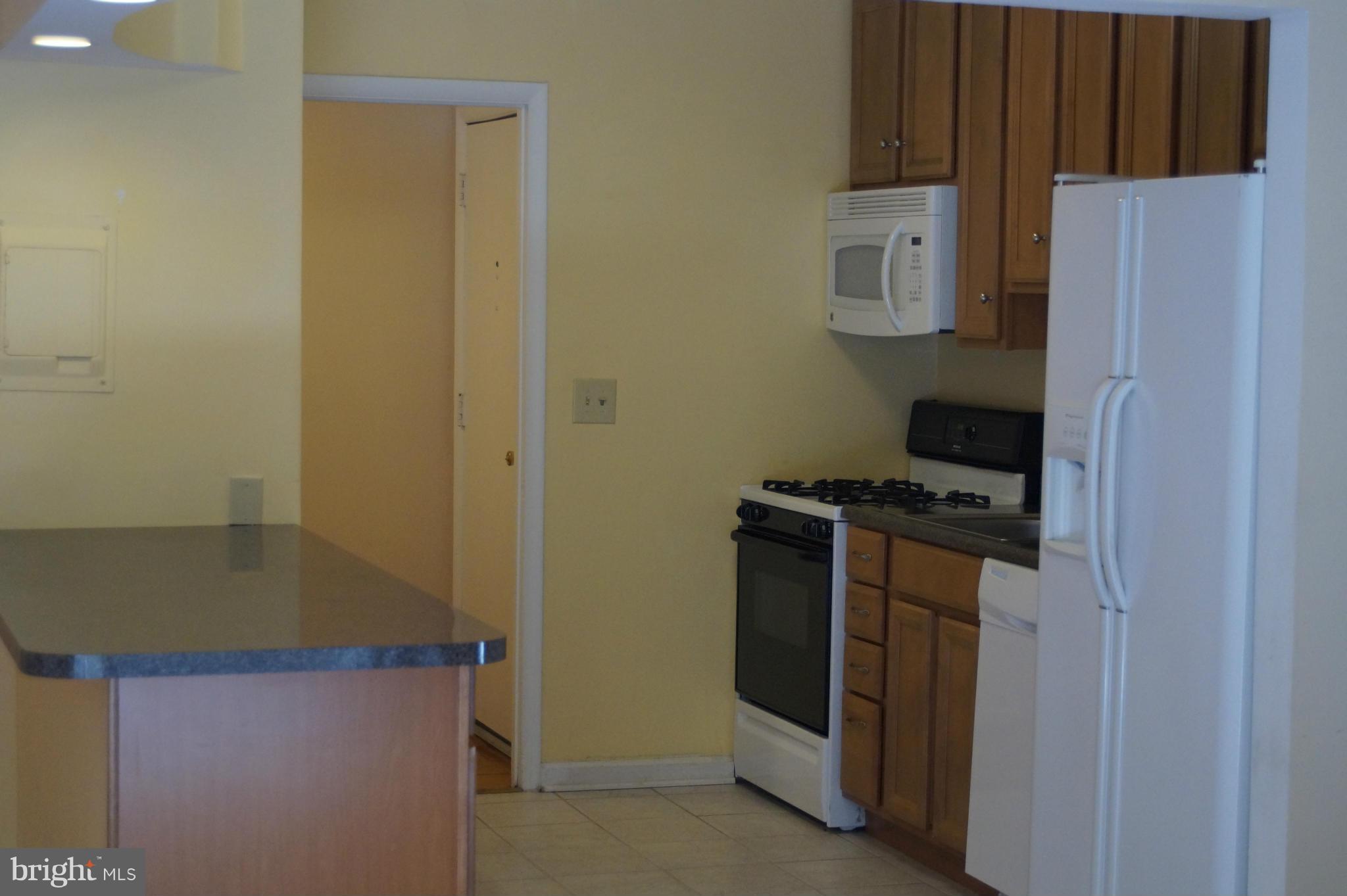 109 Cross Keys Road, Unit R109F Baltimore, MD 21210 - Photo 4 of 13 a kitchen with a refrigerator and a stove