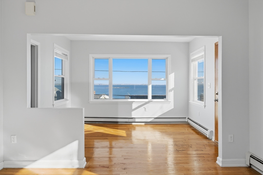 203 Endicott Avenue, Unit 2 Revere, MA 02151 - Photo 12 of 39 a view of an empty room with wooden floor and a window