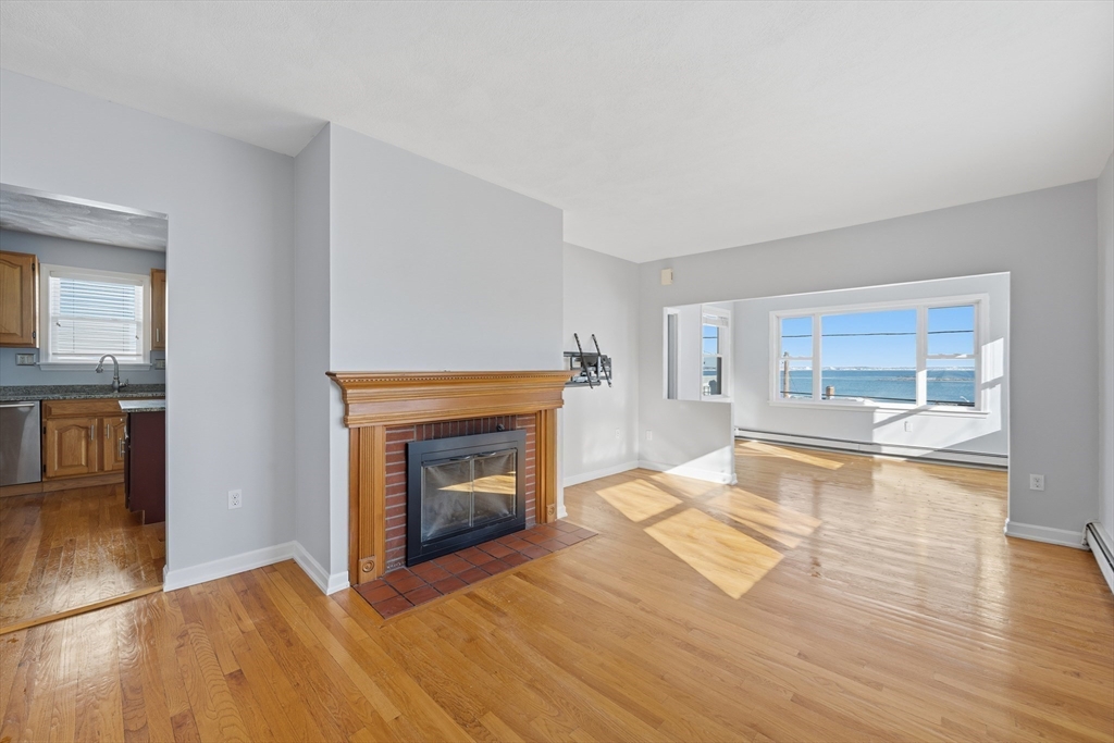 203 Endicott Avenue, Unit 2 Revere, MA 02151 - Photo 16 of 39 a view of empty room with wooden floor and fireplace