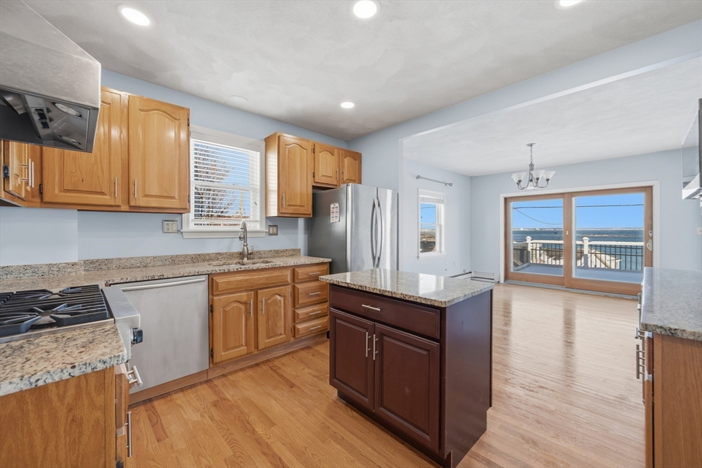 203 Endicott Avenue, Unit 2 Revere, MA 02151 - Photo 17 of 39 a kitchen with granite countertop a sink cabinets and wooden floor