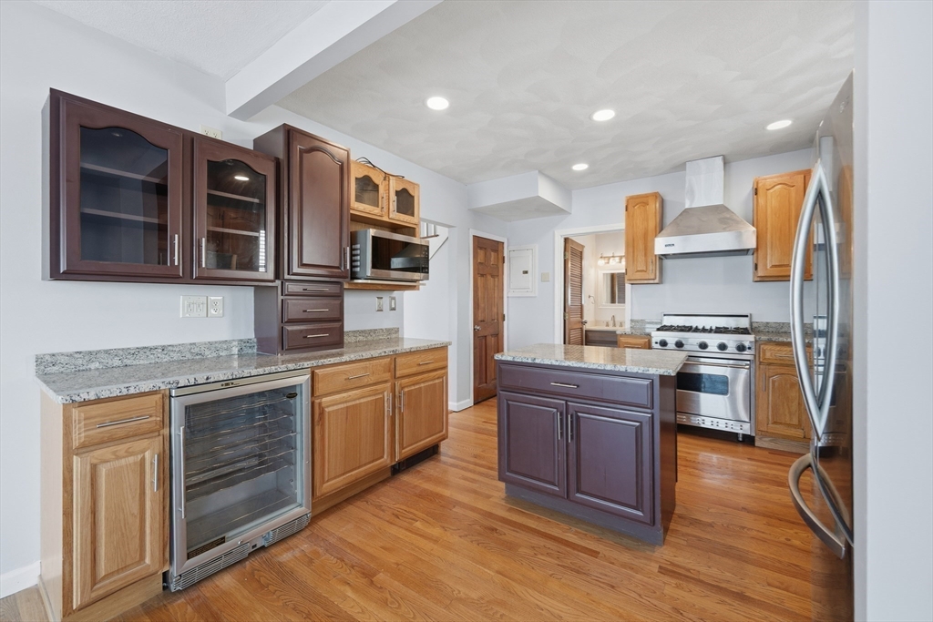 203 Endicott Avenue, Unit 2 Revere, MA 02151 - Photo 19 of 39 a kitchen with stainless steel appliances granite countertop wooden cabinets and a stove top oven
