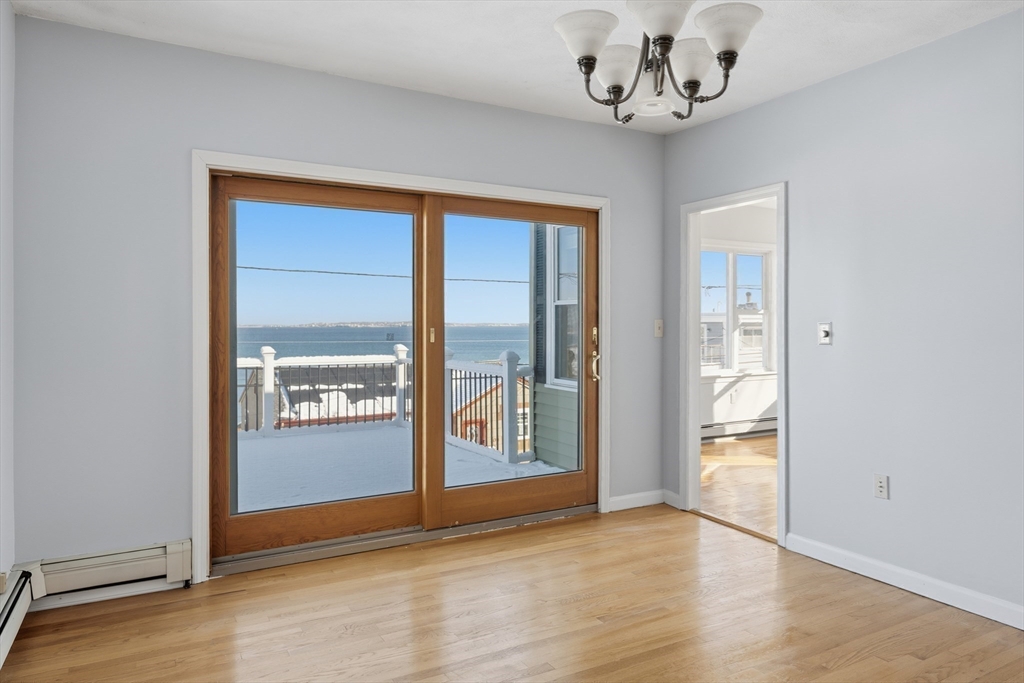 203 Endicott Avenue, Unit 2 Revere, MA 02151 - Photo 22 of 39 an empty room with wooden floor and windows