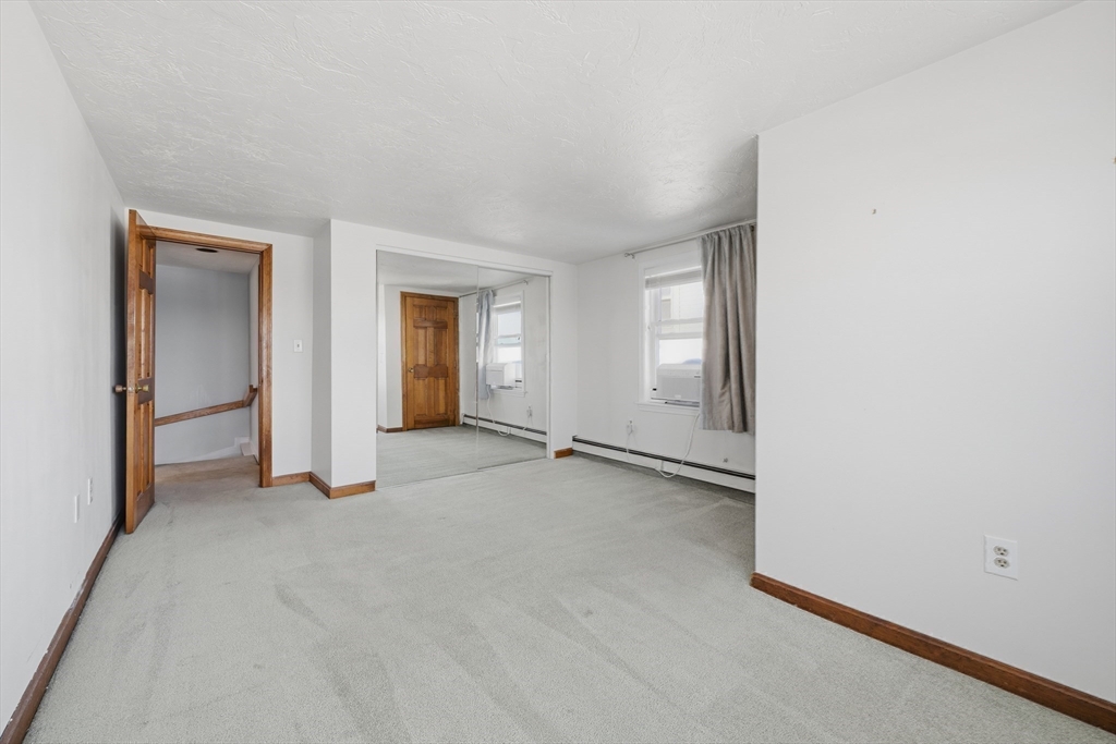 203 Endicott Avenue, Unit 2 Revere, MA 02151 - Photo 28 of 39 an empty room with windows and closet