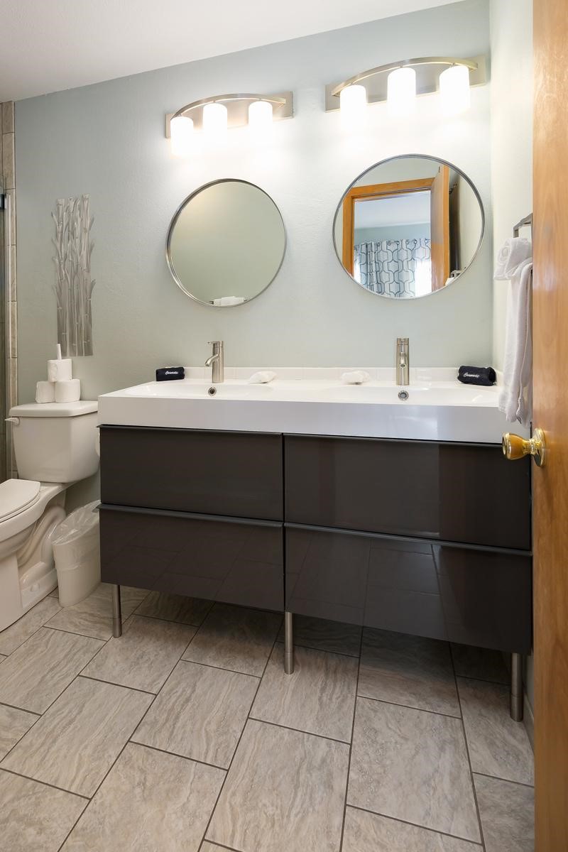 91100 Ryan Gulch Road, Unit 91105 Silverthorne, CO 80498 - Photo 22 of 49 a bathroom with a double vanity sink mirror and toilet