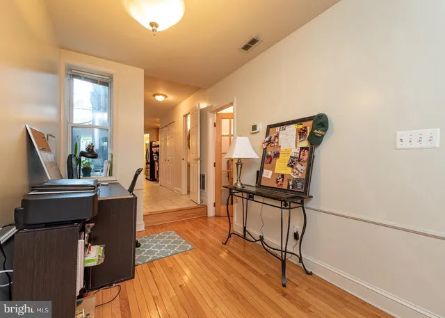 a view of a living room with furniture and wooden floor
