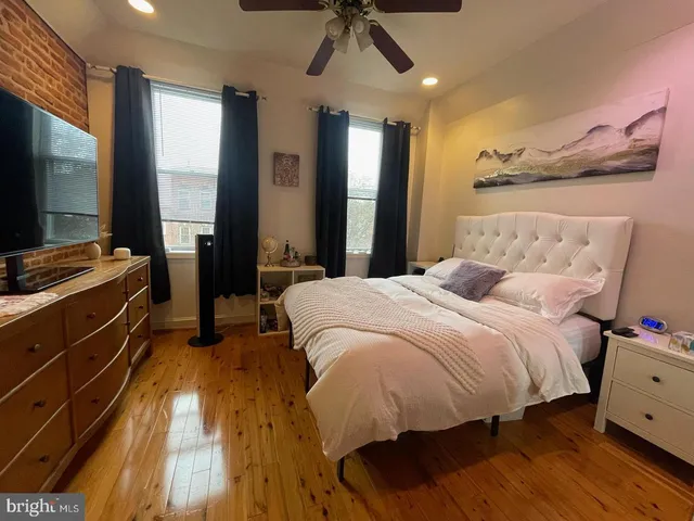 a bed room with a bed and a flat tv screen