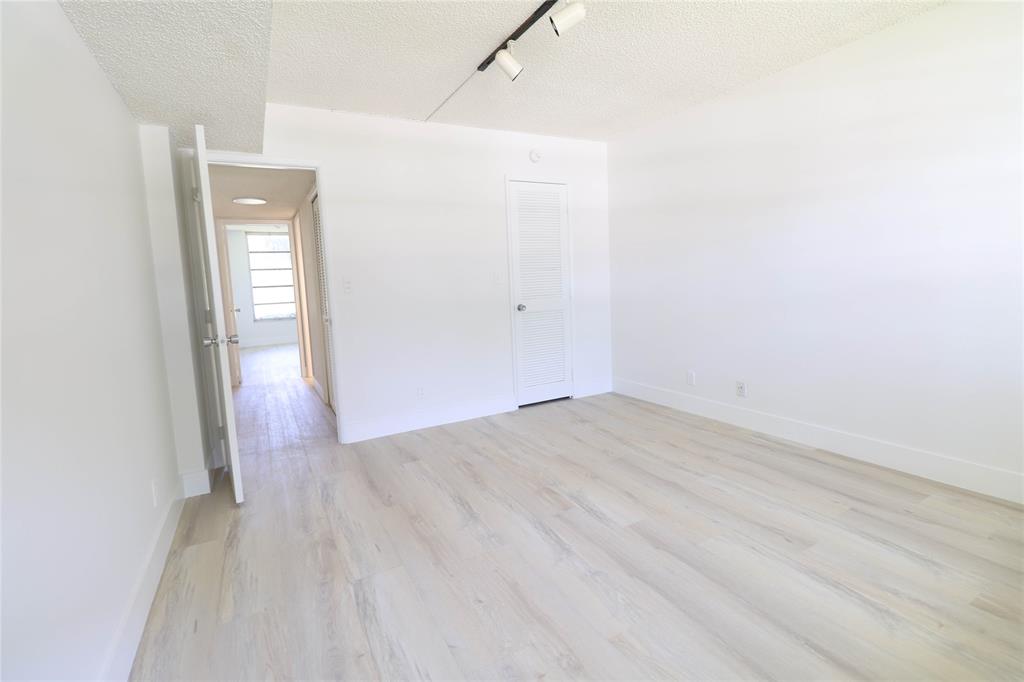 4007 North Cypress Drive, Unit 103 Pompano Beach, FL 33069 - Photo 17 of 25 a view of a small space with wooden floor and a bathroom