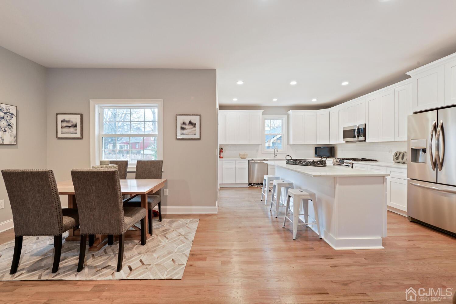 20 Sunset Drive Clark, NJ 07066 - Photo 12 of 32 a living room with stainless steel appliances kitchen island granite countertop furniture and wooden floor
