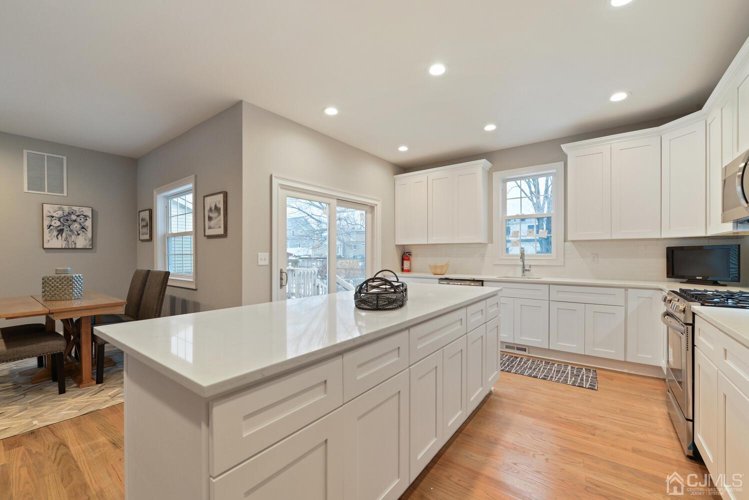 20 Sunset Drive Clark, NJ 07066 - Photo 16 of 32 a kitchen with a sink window and cabinets