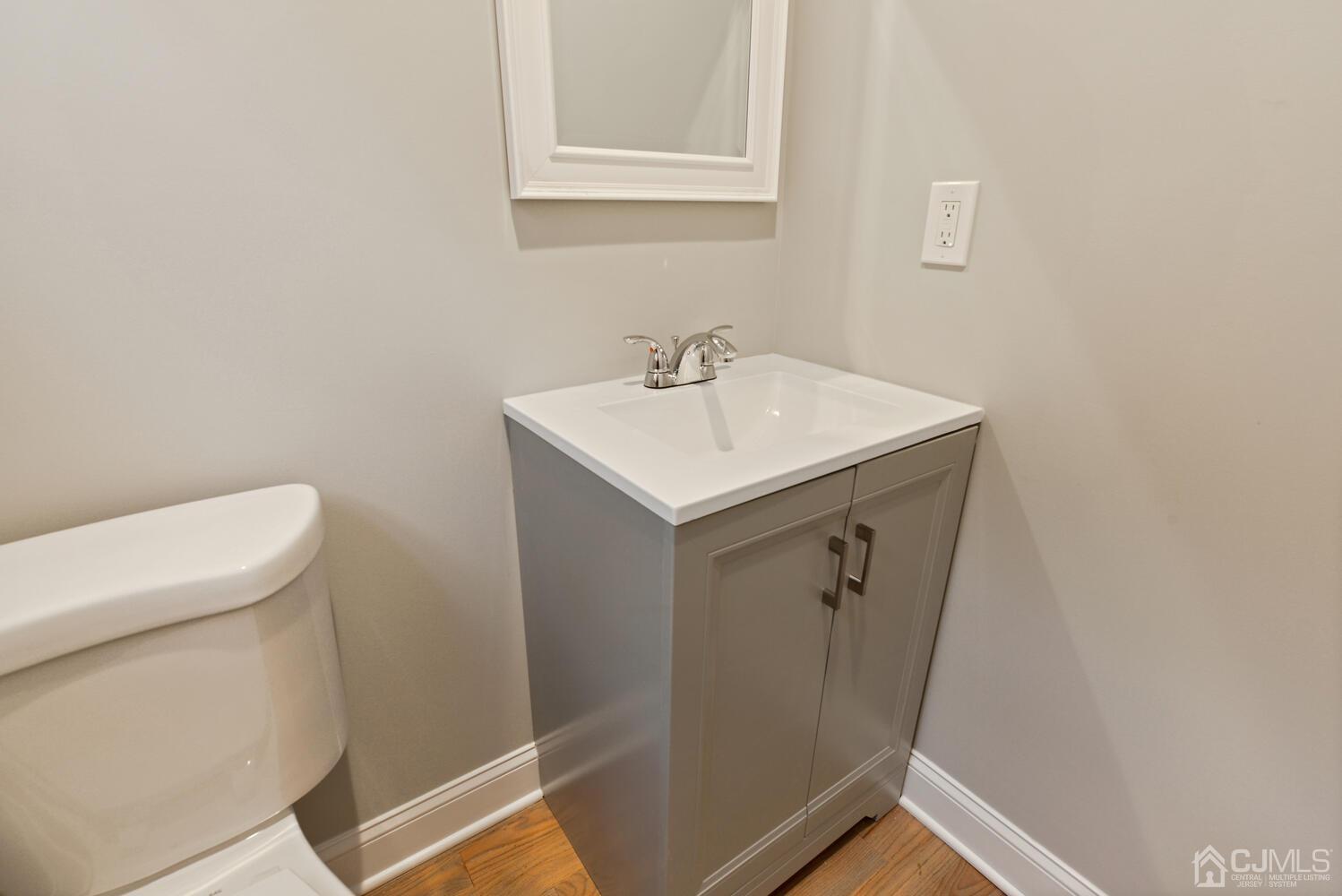 20 Sunset Drive Clark, NJ 07066 - Photo 17 of 32 a bathroom with a sink a toilet and a mirror