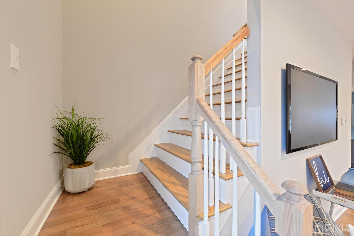 20 Sunset Drive Clark, NJ 07066 - Photo 18 of 32 a view of staircase with wooden floor and potted plant