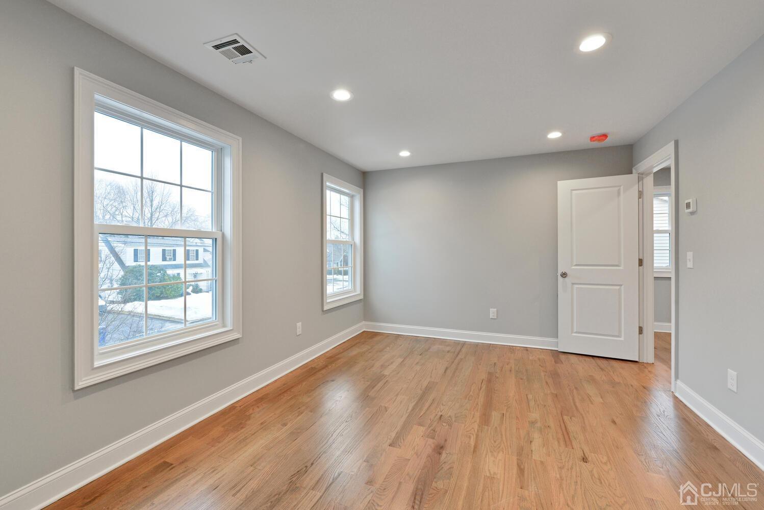 20 Sunset Drive Clark, NJ 07066 - Photo 22 of 32 a view of an empty room with wooden floor and a window